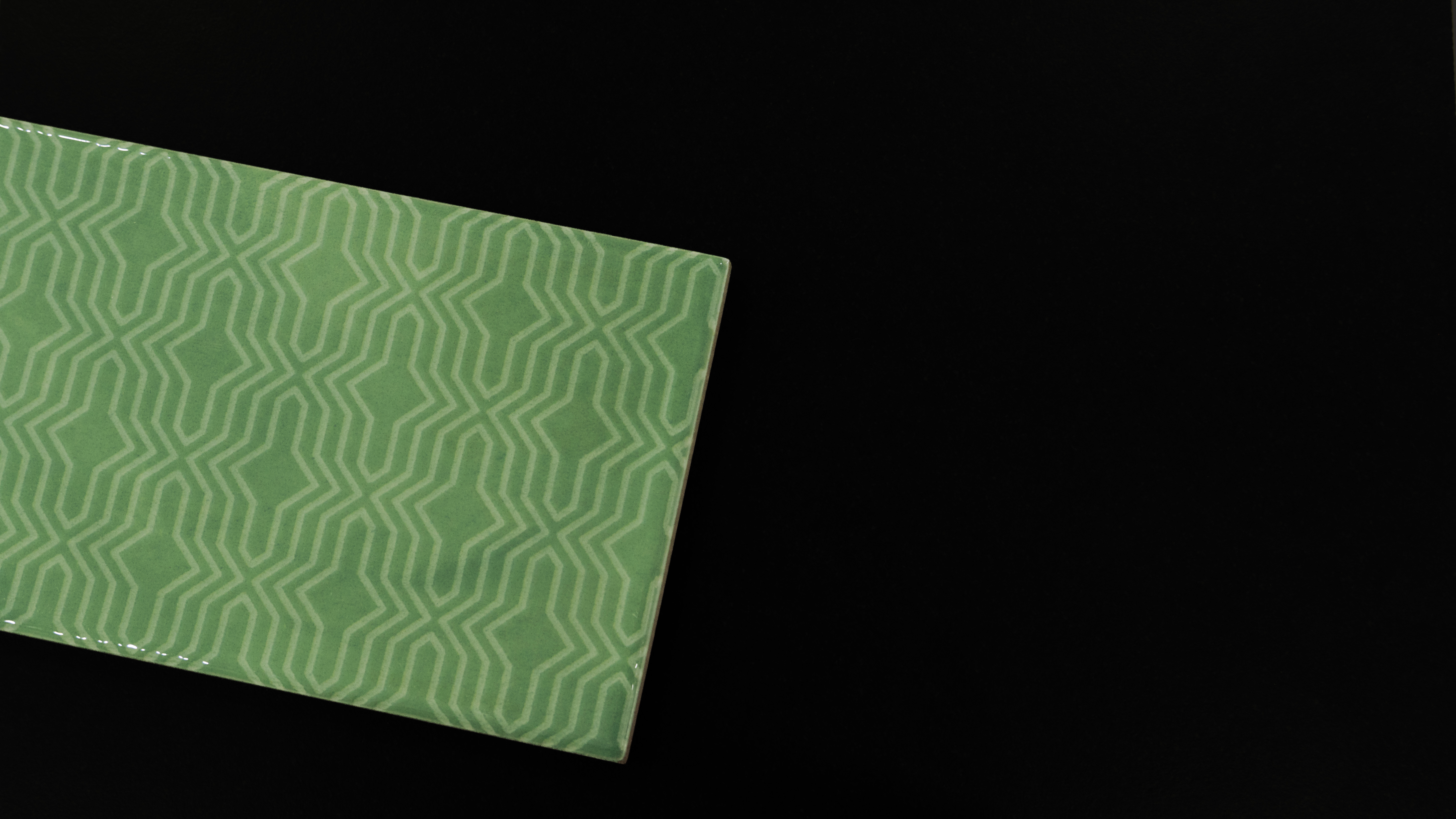 A close-up of a TL 03799 B Green Geo 300x100 mm Glossy Finish Ceramic Wall  Subway Tile - 10 mm  with a Glossy finish available at Material Depot in Bangalore