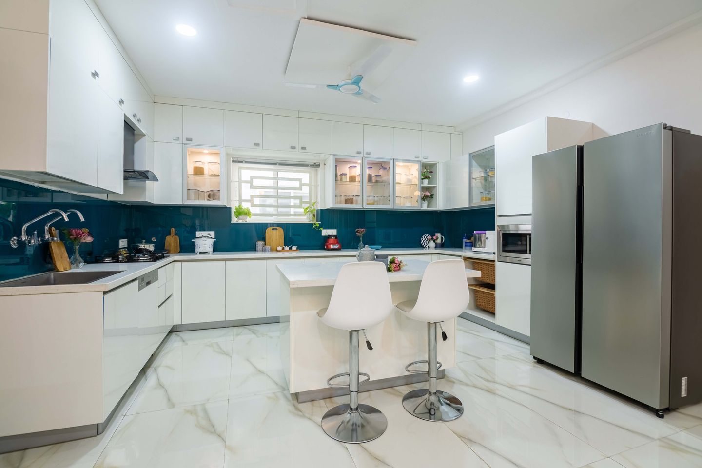 Luxurious white-themed kitchen in a Hyderabad 3 BHK villa