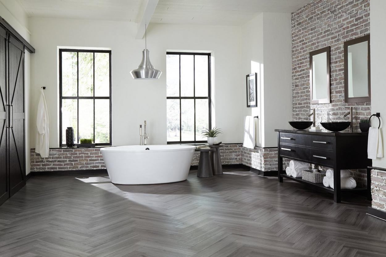 Bathroom with stone tiles and wooden floor