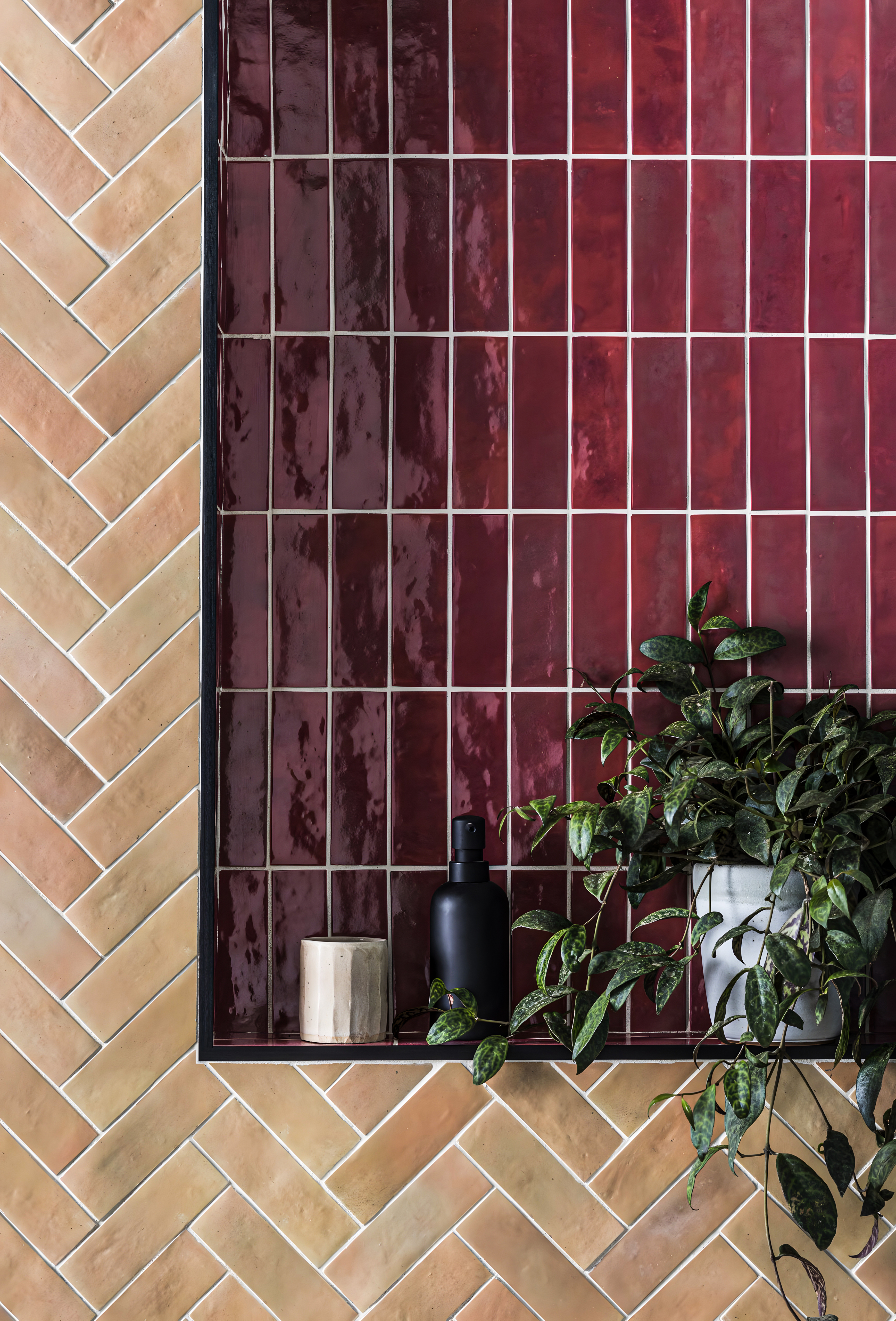 Charming Bathroom Detail Featuring Herringbone and Glossy Tile Accents with Lush Greenery | Material Depot