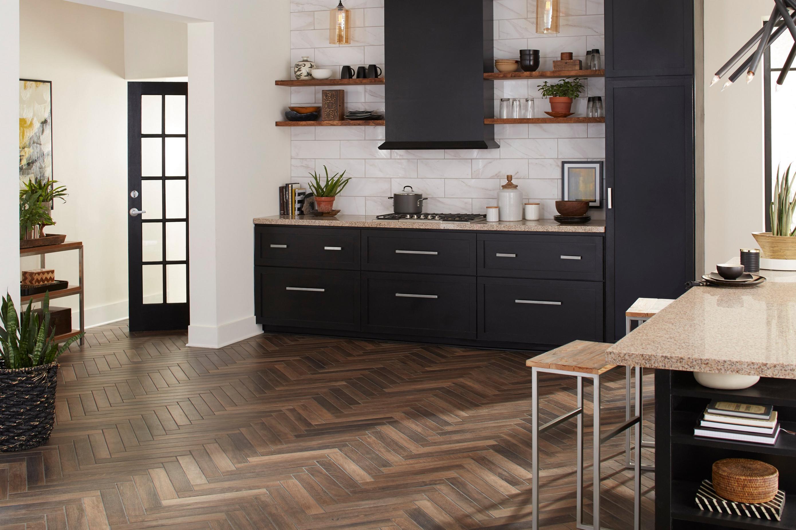 Kitchen with patterned wooden floor and black laminate