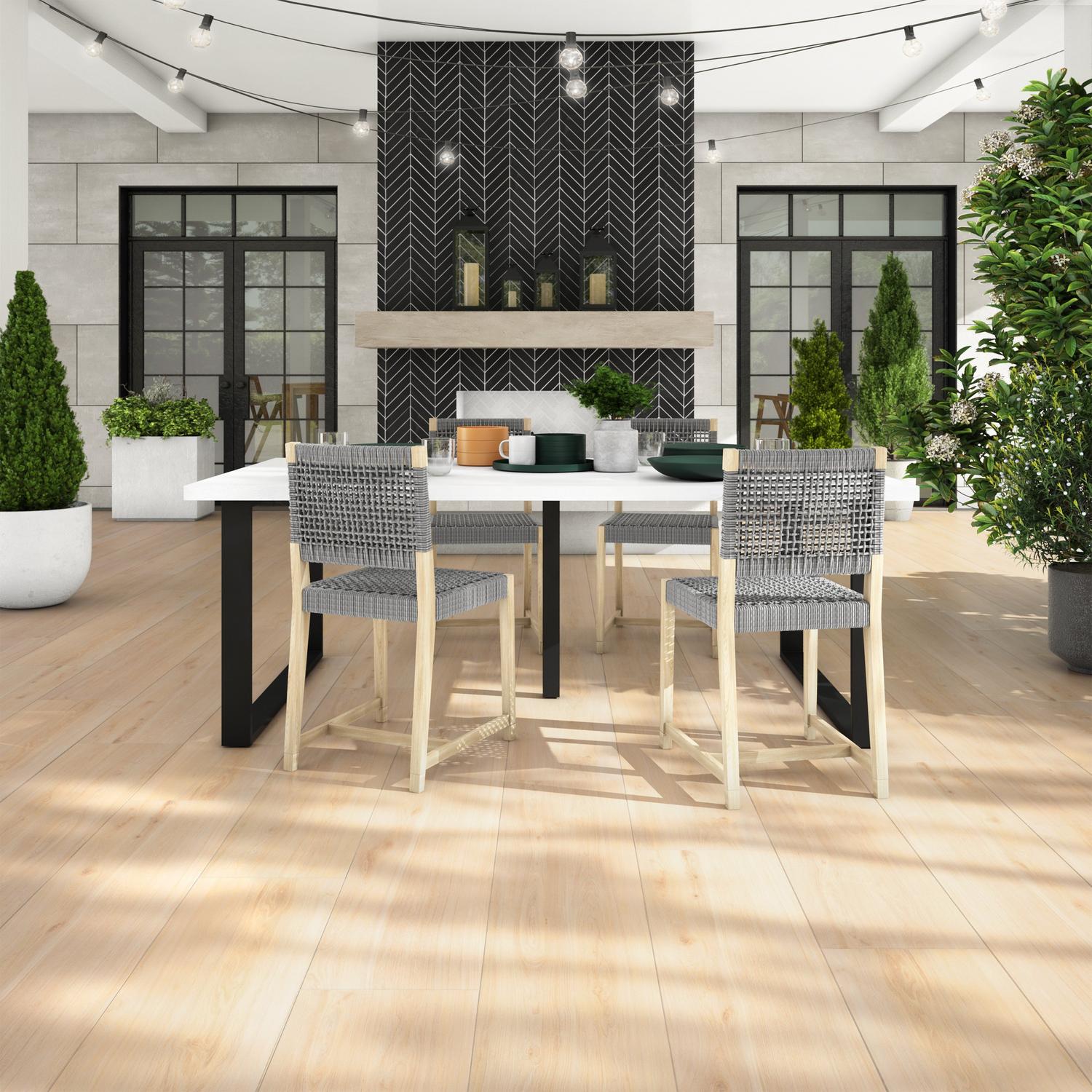 Dining area with beige wooden laminate flooring and black patterned tiles