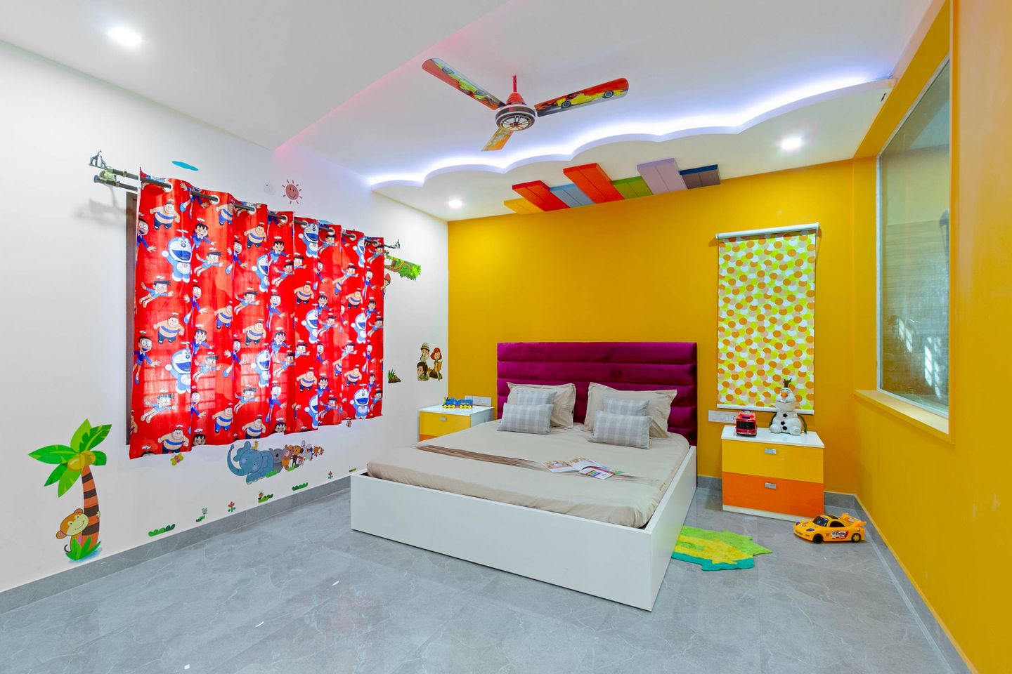 Kids' room with grey marble tile floor and multiple coloured wall