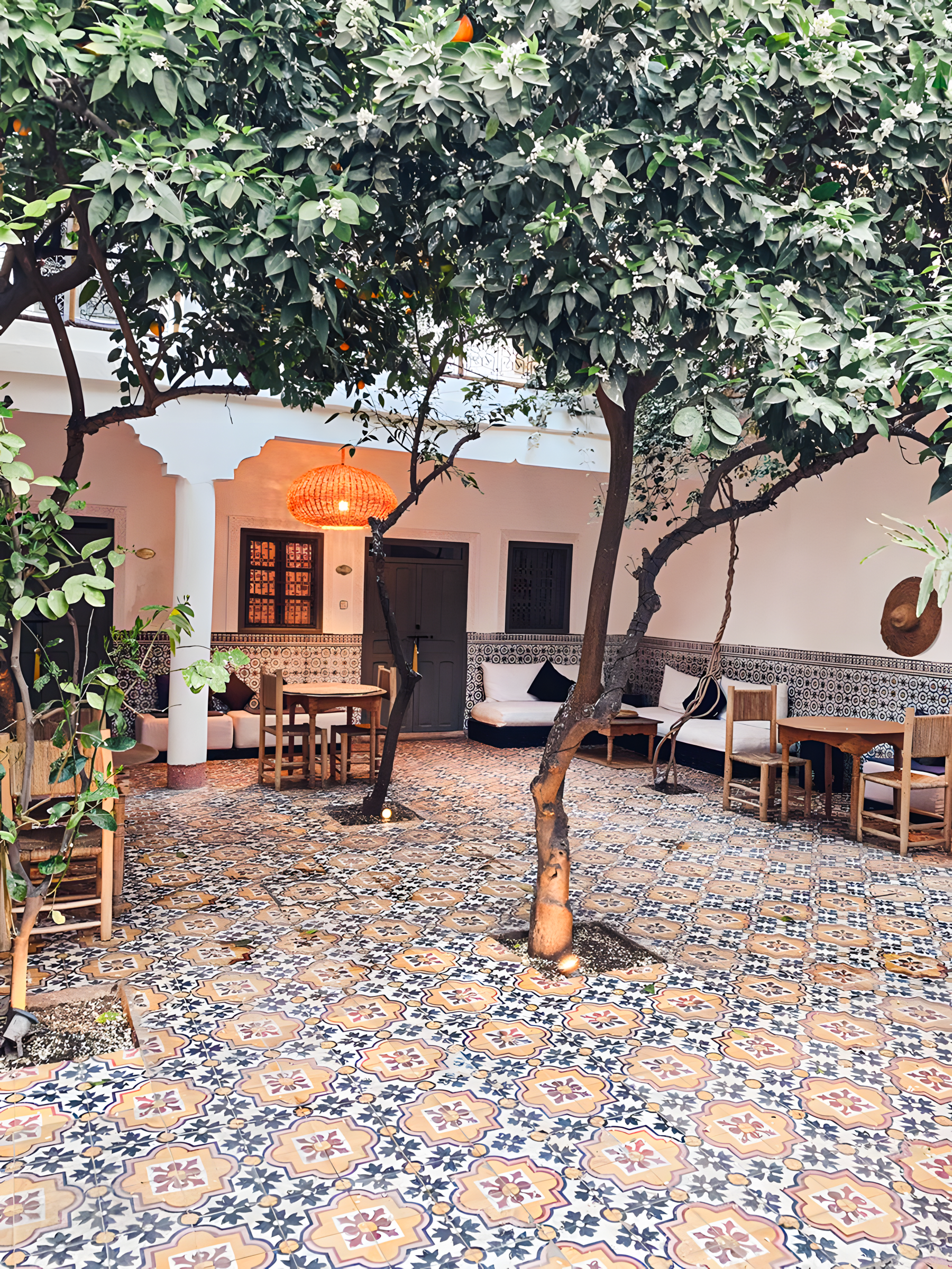 Moroccan-Inspired Courtyard with Patterned Tiles and Orange Tree | Material Depot