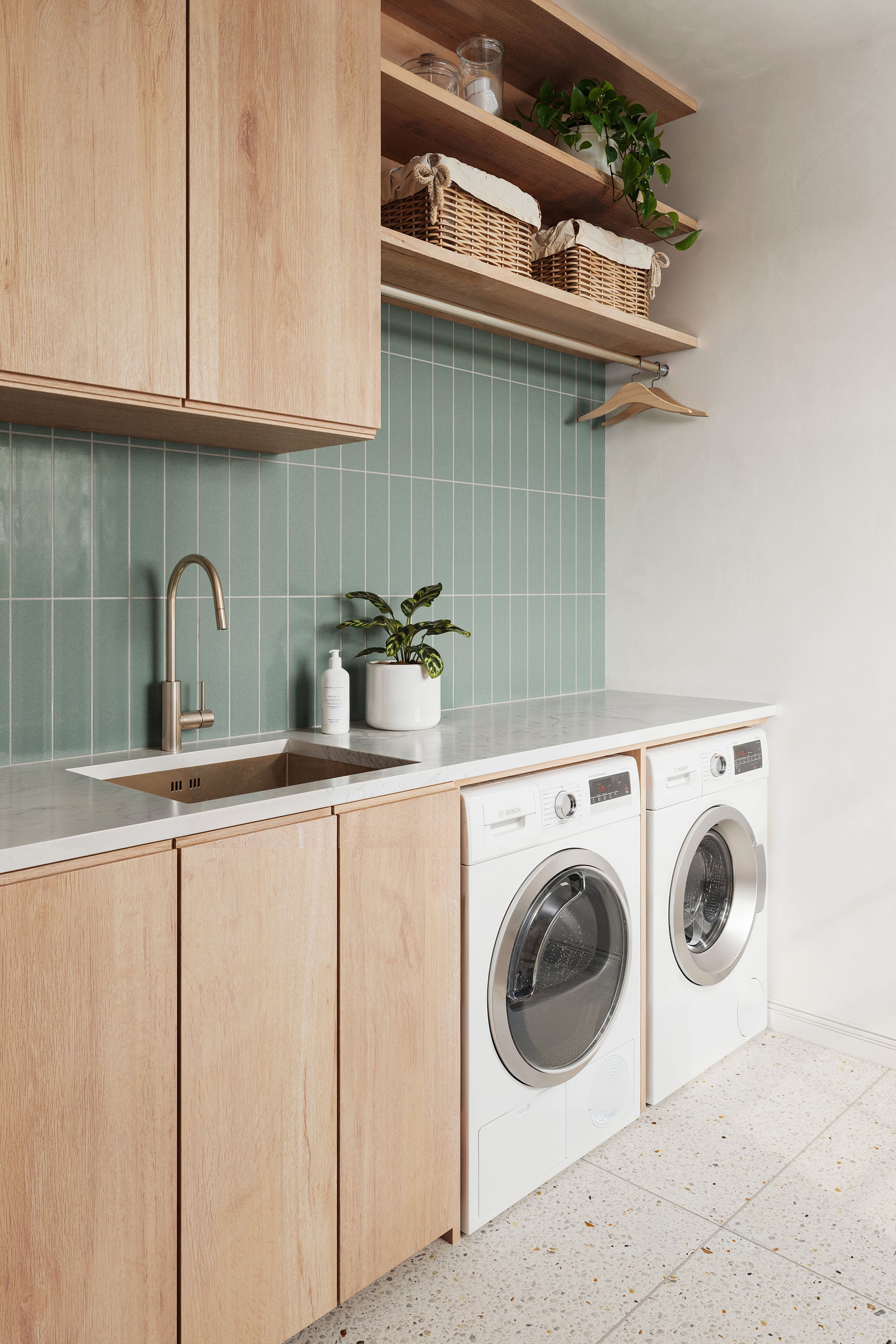 Serene Green Tiled Laundry Room with Wood Cabinets and Terrazzo Floor | Material Depot