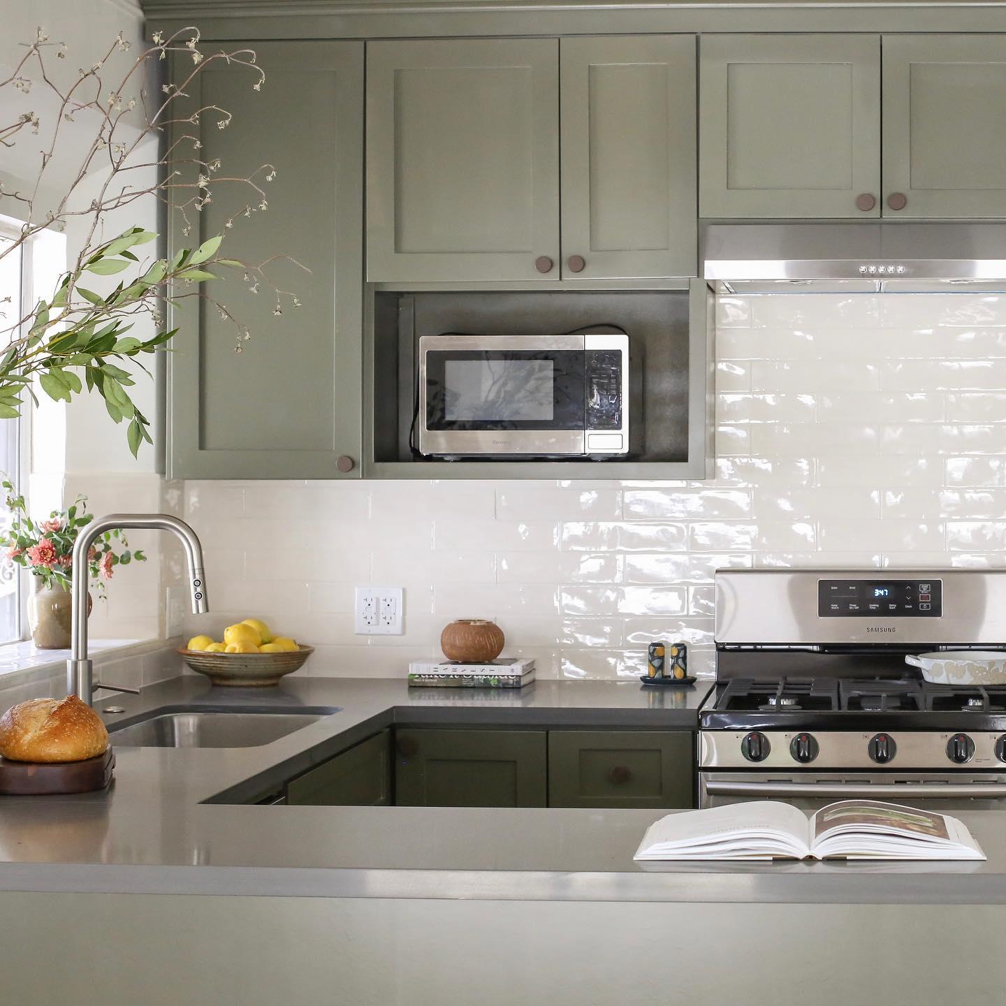 Kitchen unit with green laminate cabinet and faucet