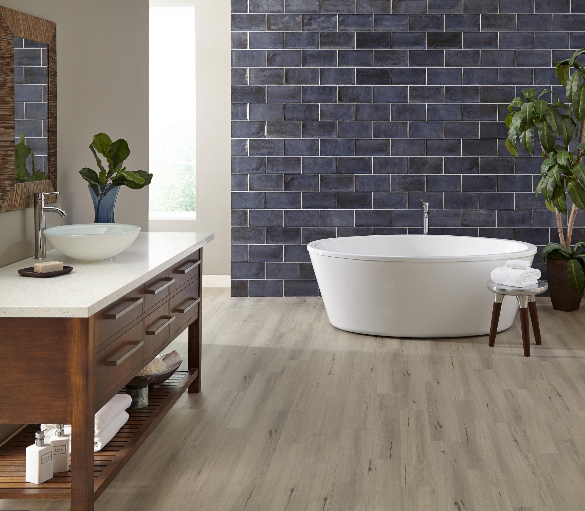 Bathroom with blue tile and wooden floor