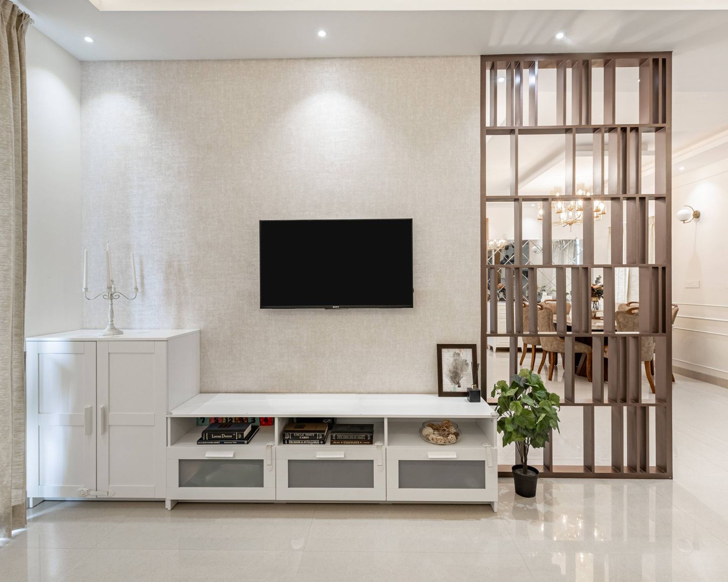 A spacious living room with a TV and a bookshelf