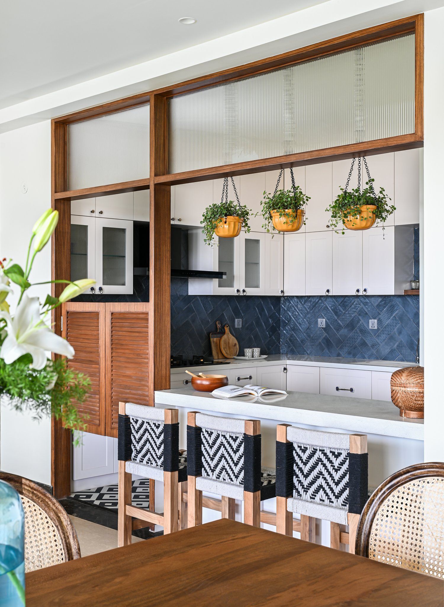 Stylish Open Kitchen Design Featuring White Cabinets, Modern Blue Backsplash, and Chic Wood Accents | Material Depot