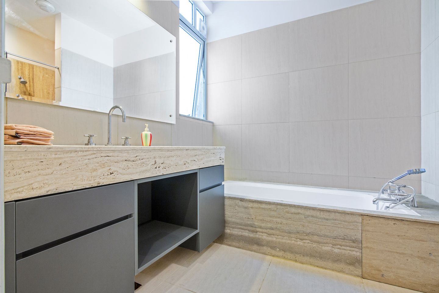 Contemporary bathroom with textured wall tiles.